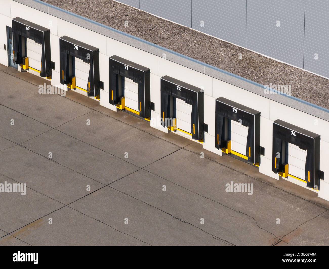 Logistics center features multiple loading docks and freight trucks ...