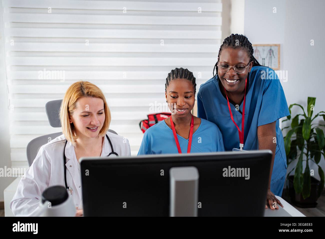 Diverse medical team collaborating on digital healthcare solutions Stock Photo