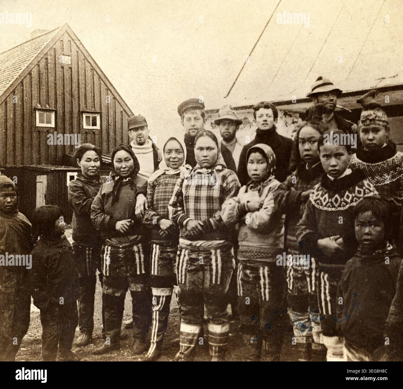 Inuit girls stand with members of the crew of the S.S. Eric at ...