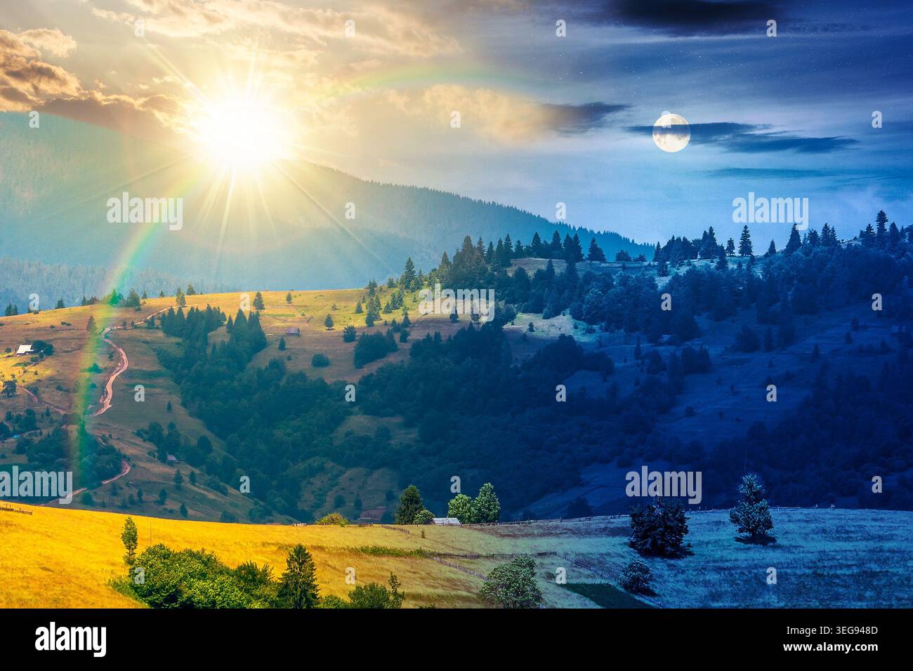 agricultural field on hillside in mountains near village. day meet night. summer solstice. sun and moon in harmony over green carpathian mountain land Stock Photo