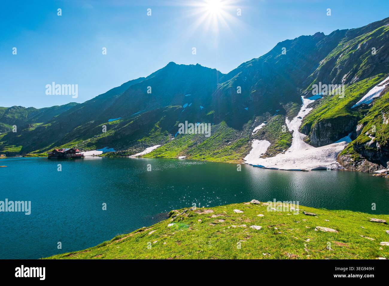 beautiful alpine scenery of fagaras mountains. balea lake in romania mountain landscape. summer weather with clouds on sky. view of rippled water near Stock Photo
