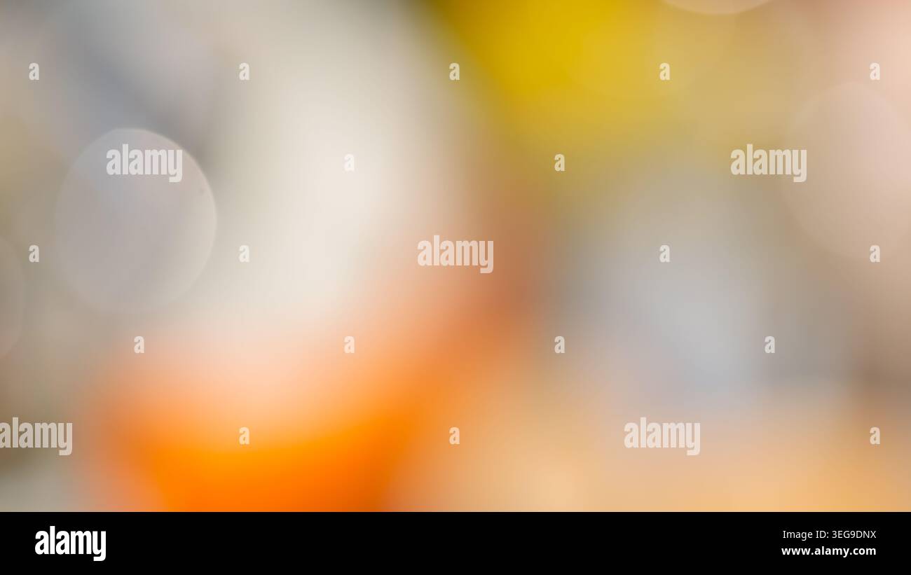Warm abstract bokeh background with orange yellow and gray blurred circular light spots Stock Photo
