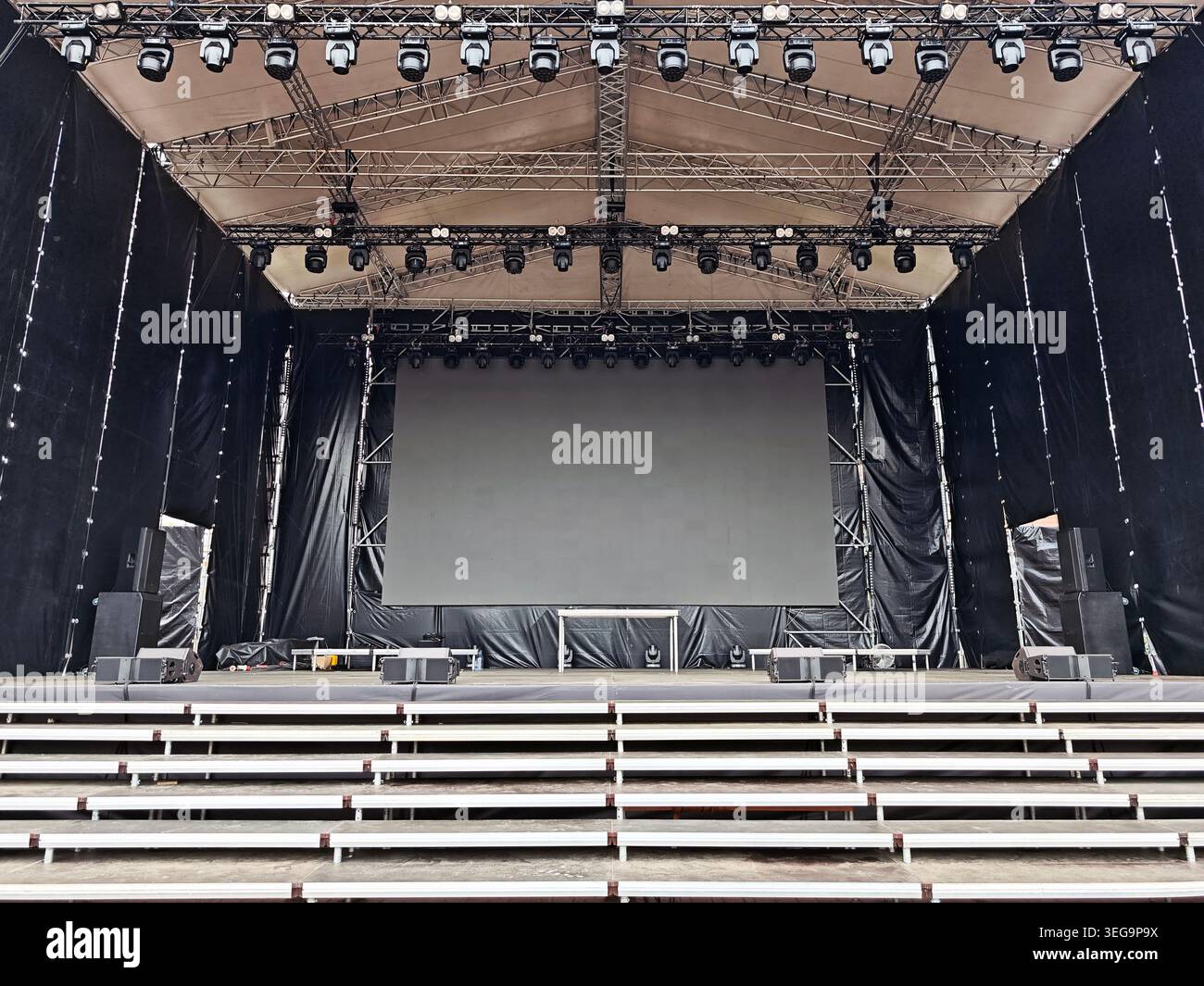 Empty outdoor concert stage equipped with professional lighting rig ...