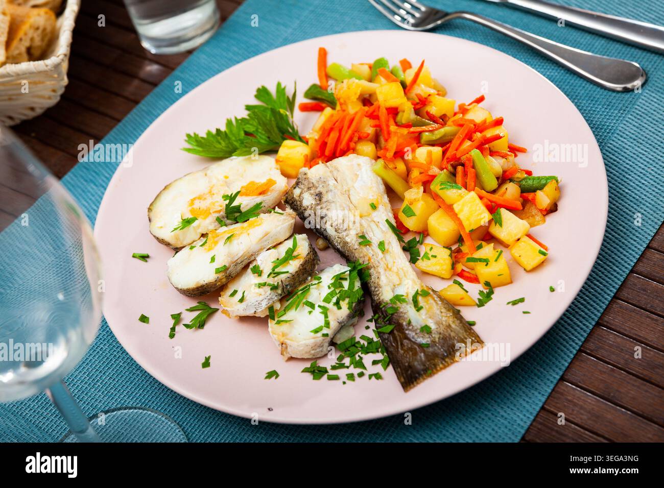 Oven baked hake with vegetable garnish Stock Photo