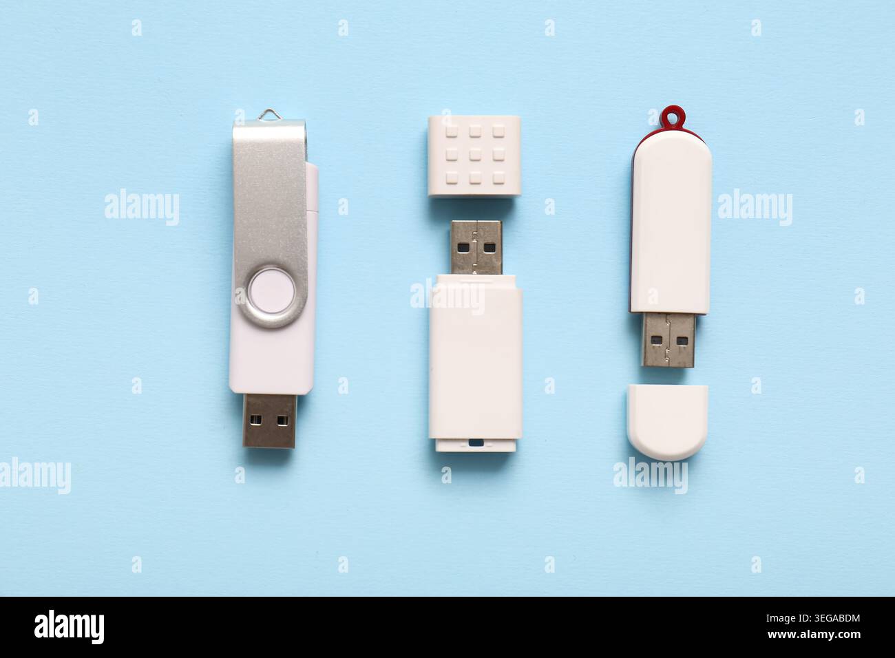 Different USB flash drives on blue background Stock Photo
