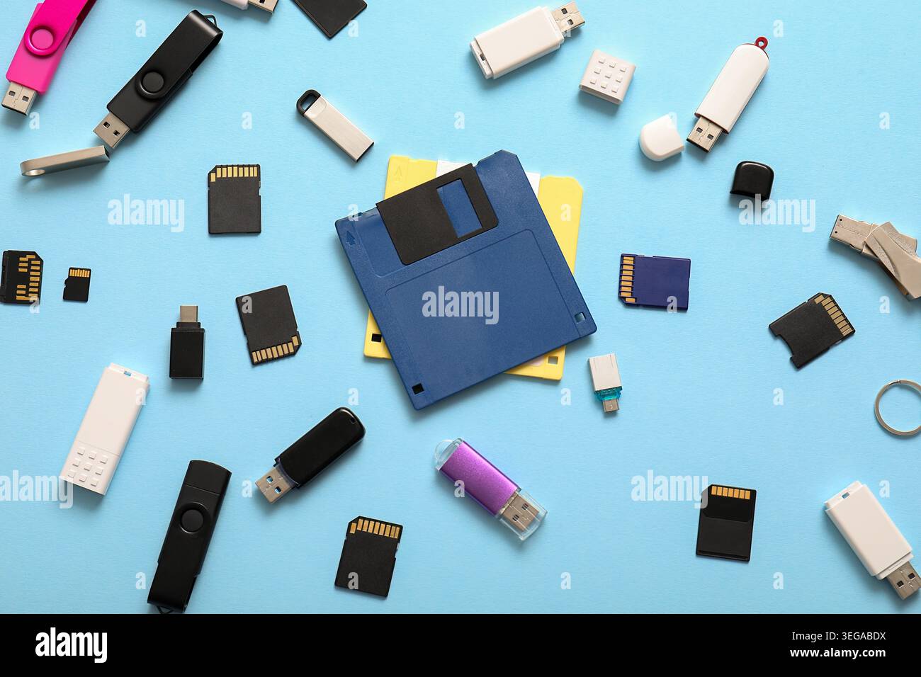 Composition with floppy disks, USB flash drives and SD cards on blue background Stock Photo