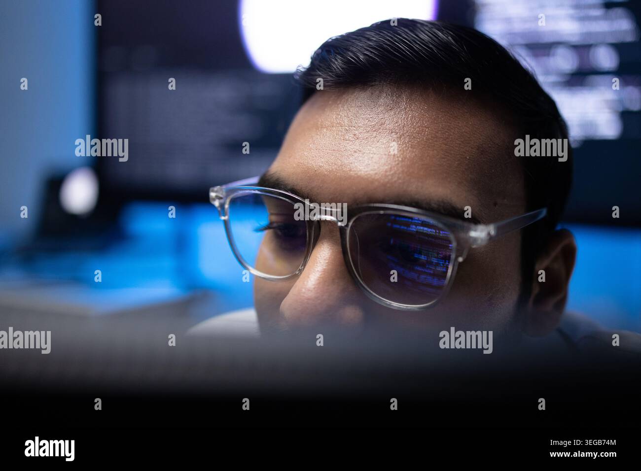 Indian Software Developer Wearing Glasses With Code Reflection On Lens Stock Photo