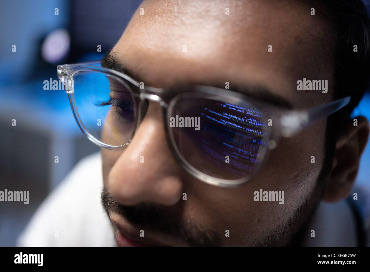 Indian Software Developer Wearing Glasses With Code Reflection On Lens Stock Photo