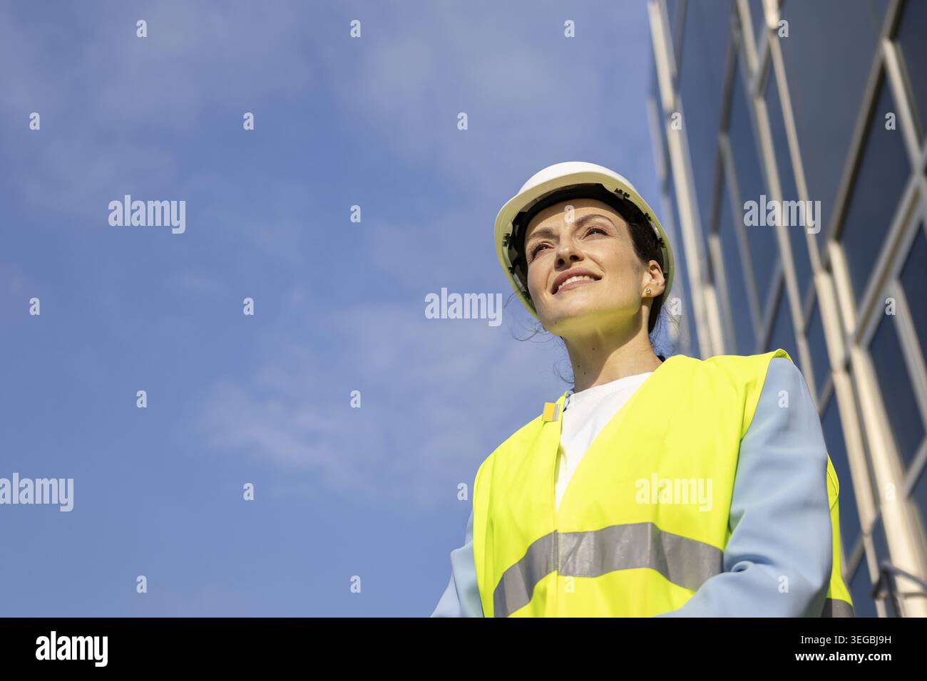 Portrait of a happy construction worker in a safety vest. Copy space Stock Photo