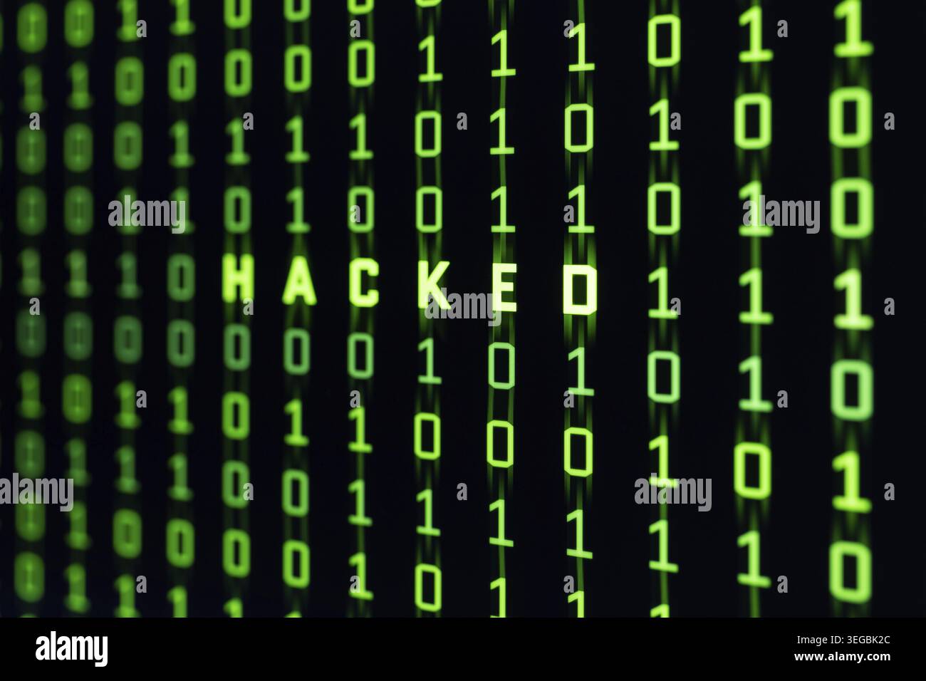 Hacked word on binary code background of a computer screen Stock Photo