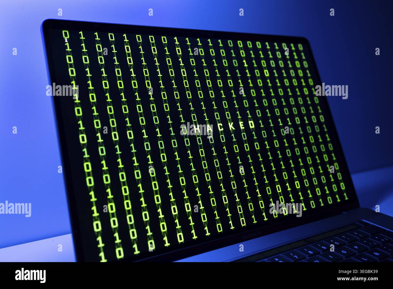 Computer Hacked concept. Laptop screen with hacked word and binary code background Stock Photo