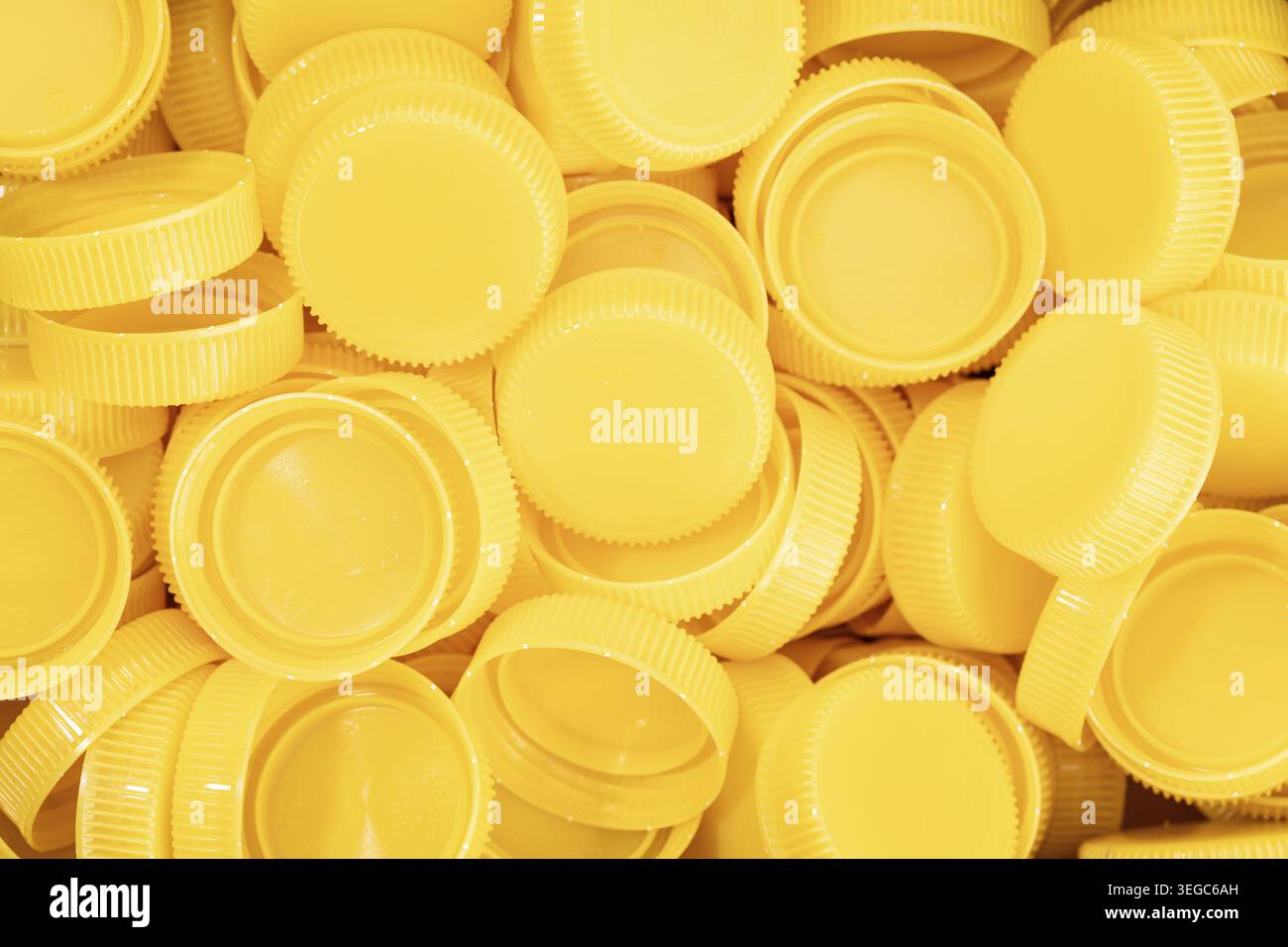 Yellow plastic screw caps background Stock Photo