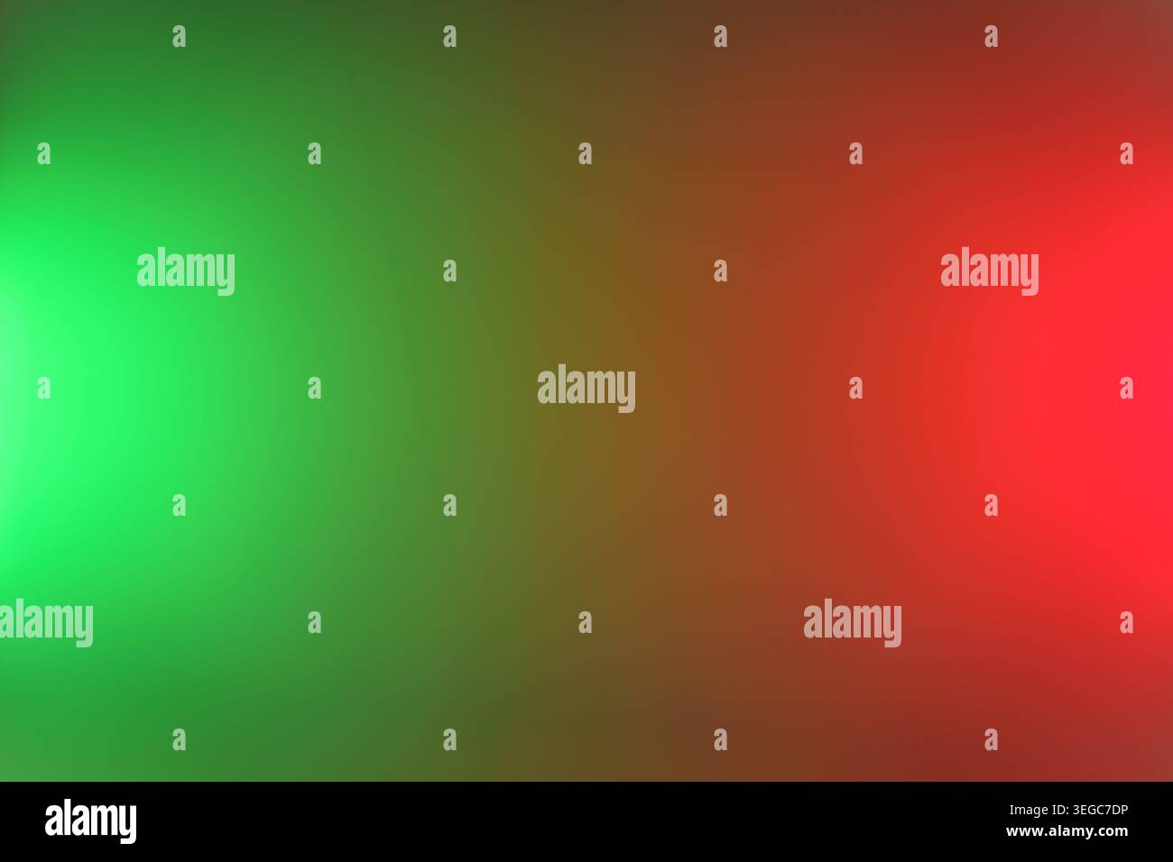 Abstract blurred gradient background featuring bright green and red light flares, soft bokeh tones and smooth color transition, ideal for festive, hol Stock Photo