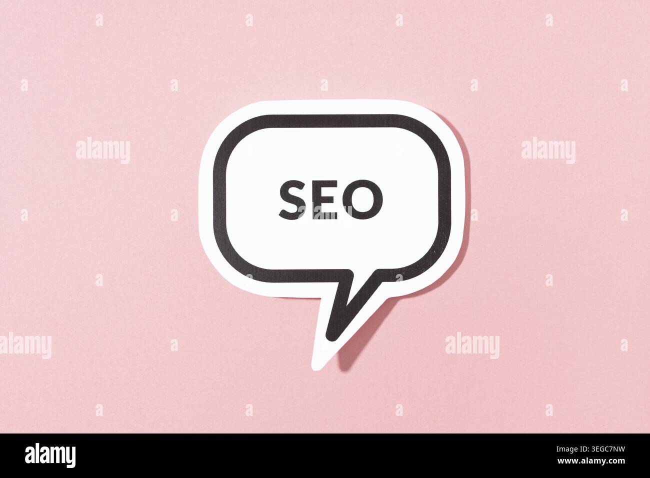 SEO text on speech bubble isolated on pink background Stock Photo