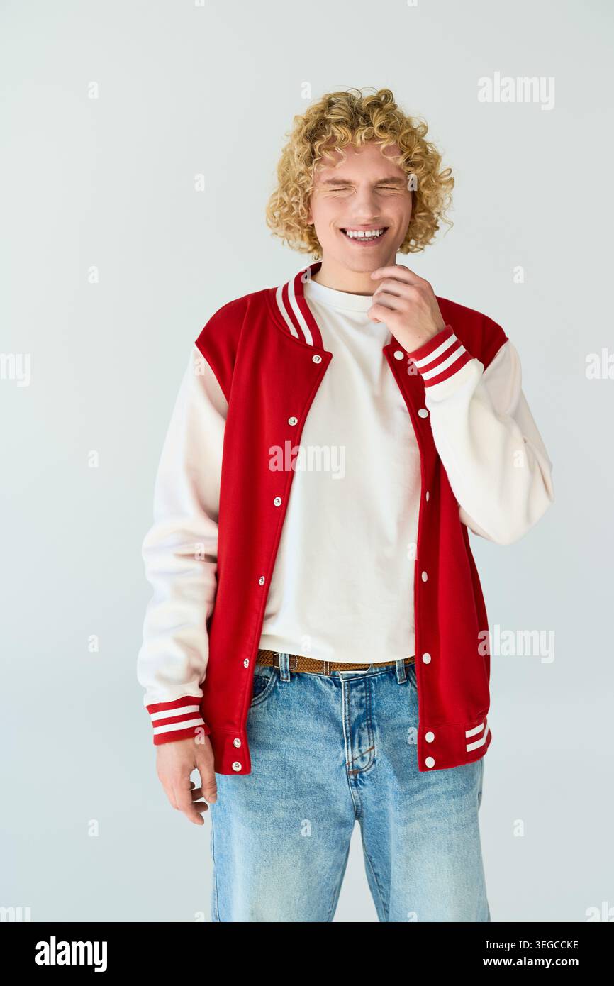 Blonde curly haired student showcases his fashionable look in a studio setting Stock Photo
