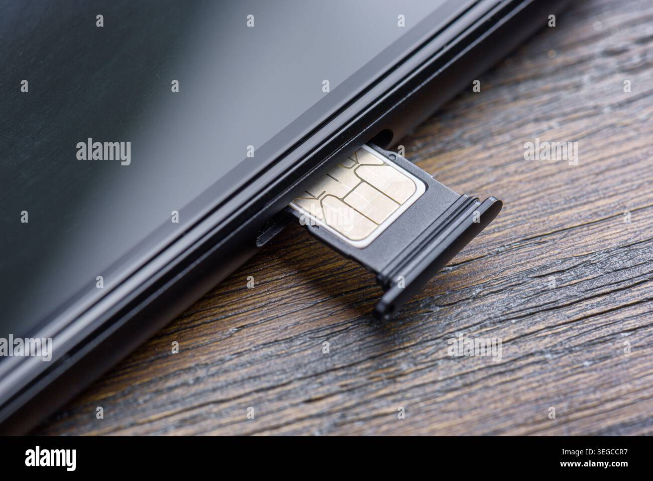 Inserting a modern nano SIM card into a Smartphone Stock Photo