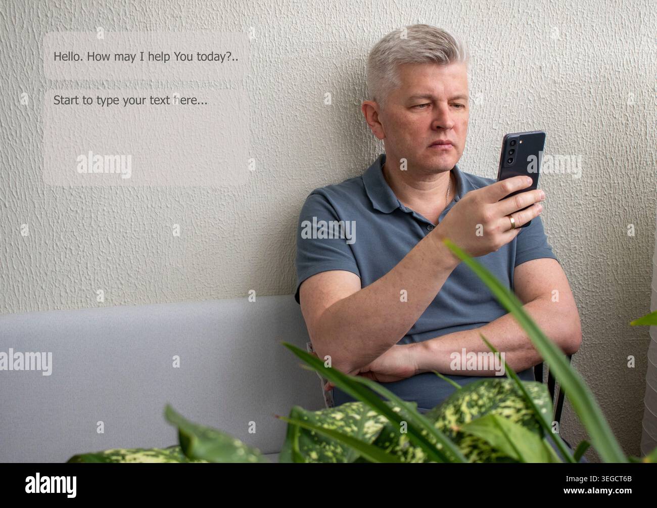 A man sitting on a sofa while looking at a smartphone, engaging with AI tool Stock Photo