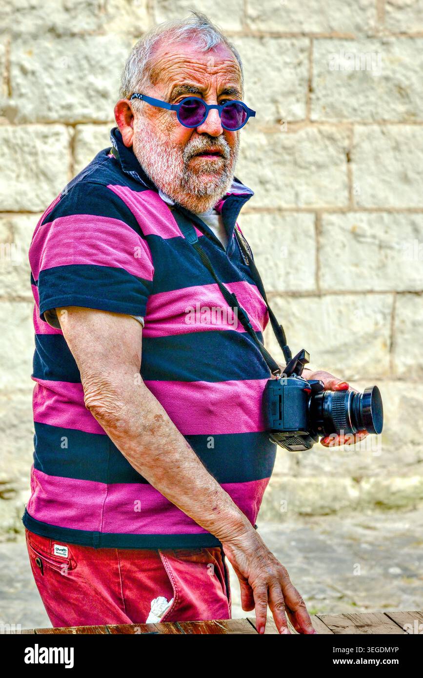 Amateur photographer with Nikon DSLR around his neck - Beaulieu-les-Loches, Indre-et-Loire (37), France. Stock Photo