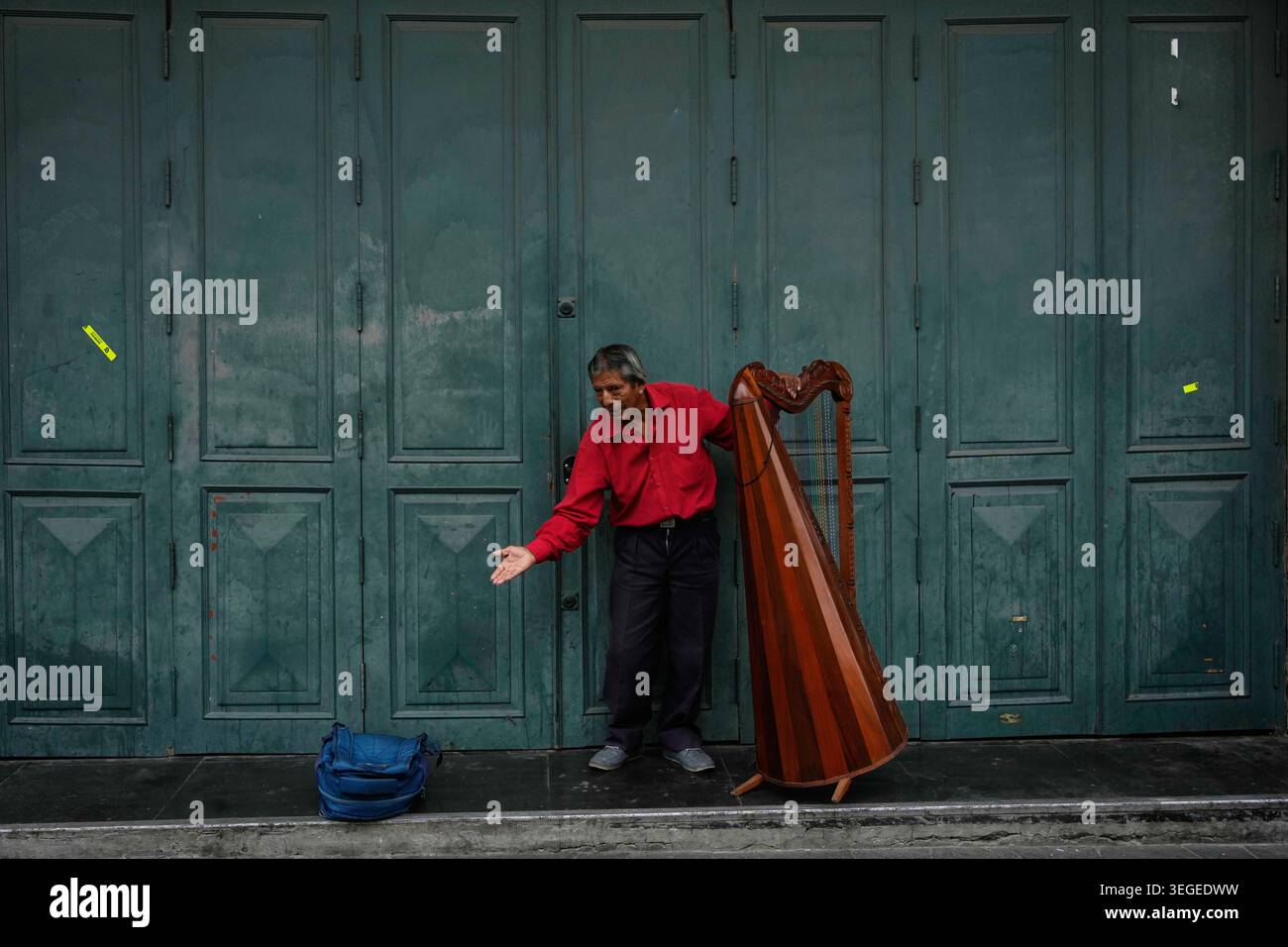 A harp player bows after playing a song in downtown Lima, Peru, Tuesday ...