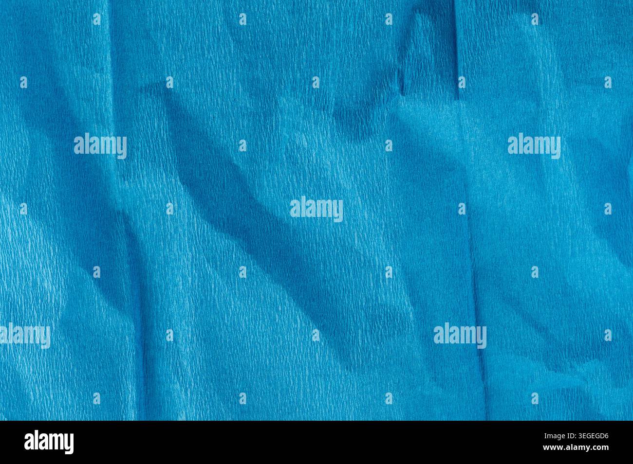 Blue matte wrinkled paper texture background macro close up view Stock Photo