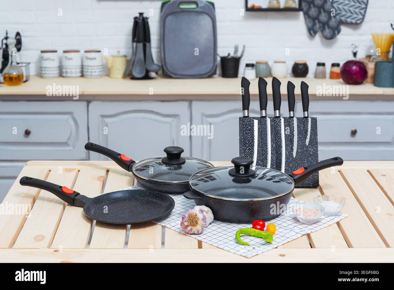 Various Cookware On Rustic Table. Cooking Utensils Spread On Wooden Surface Today Stock Photo