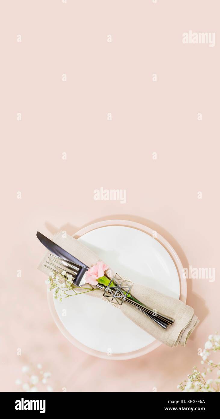 Rustic Wedding Table Setting With Knife And Fork Wrapped In Linen On Plate Stock Photo