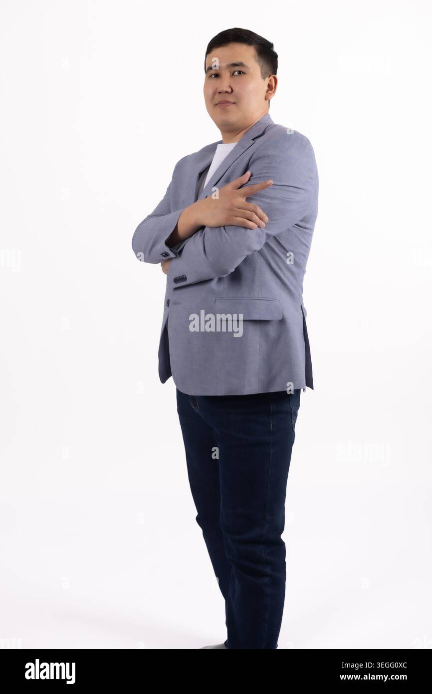 Confident businessman standing with hands in pockets looking camera Stock Photo