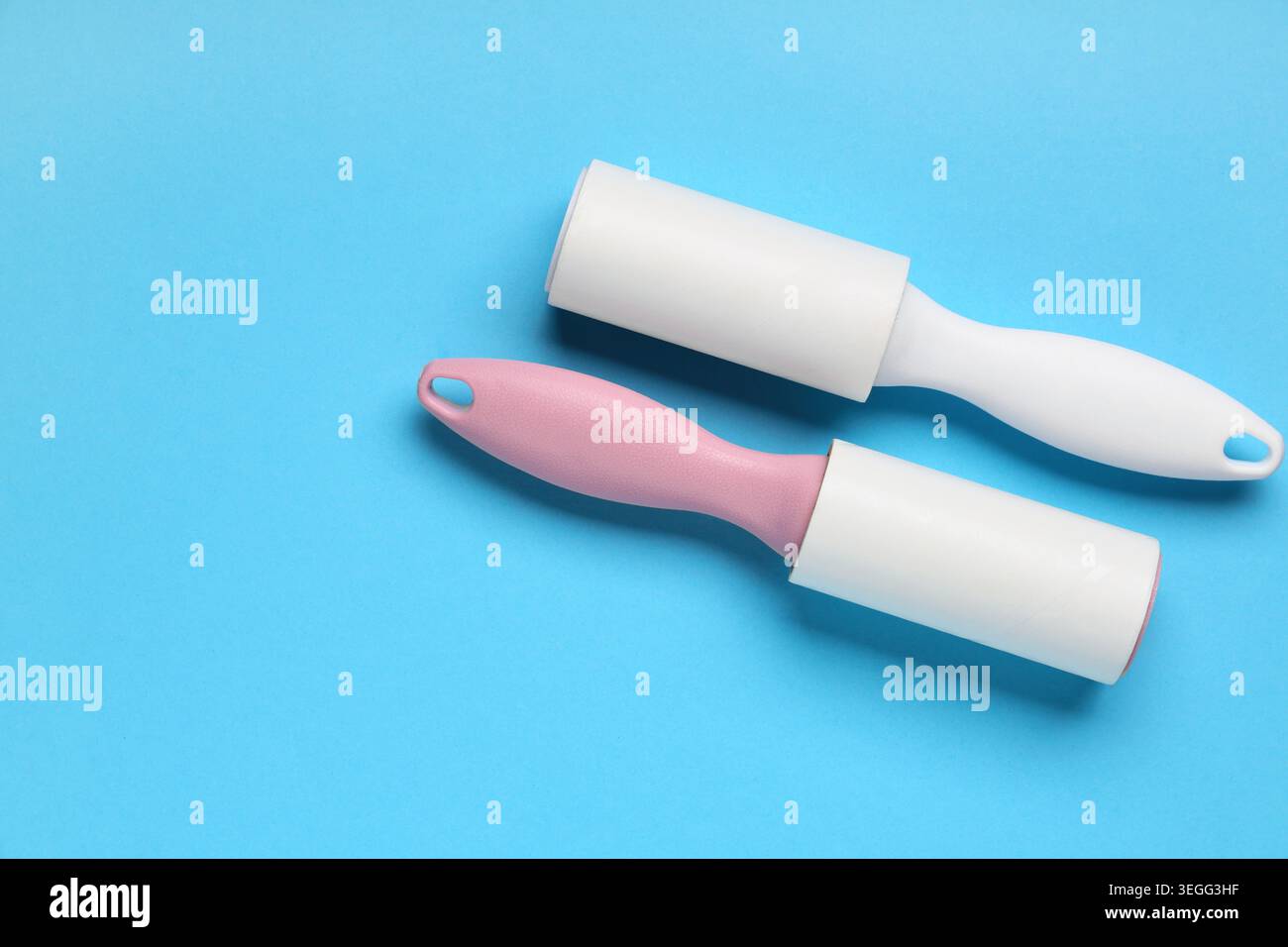 Sticky lint rollers on blue background Stock Photo