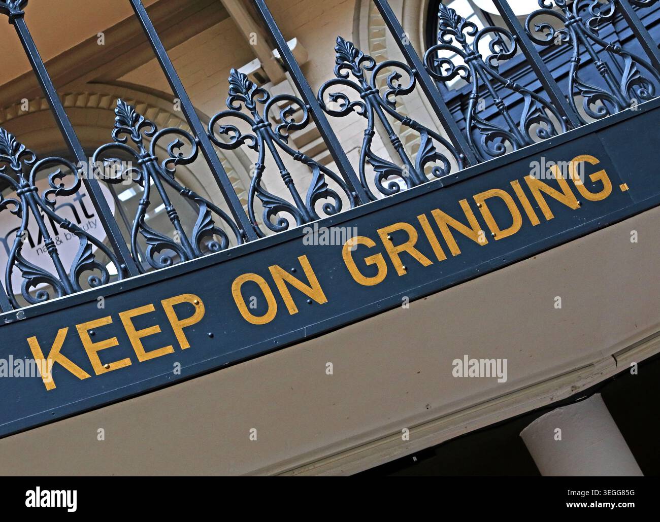 KEEP ON GRINDING lettering and ironwork inside Leeds Corn Exchange, Leeds, West Yorkshire, England, UK. Stock Photo