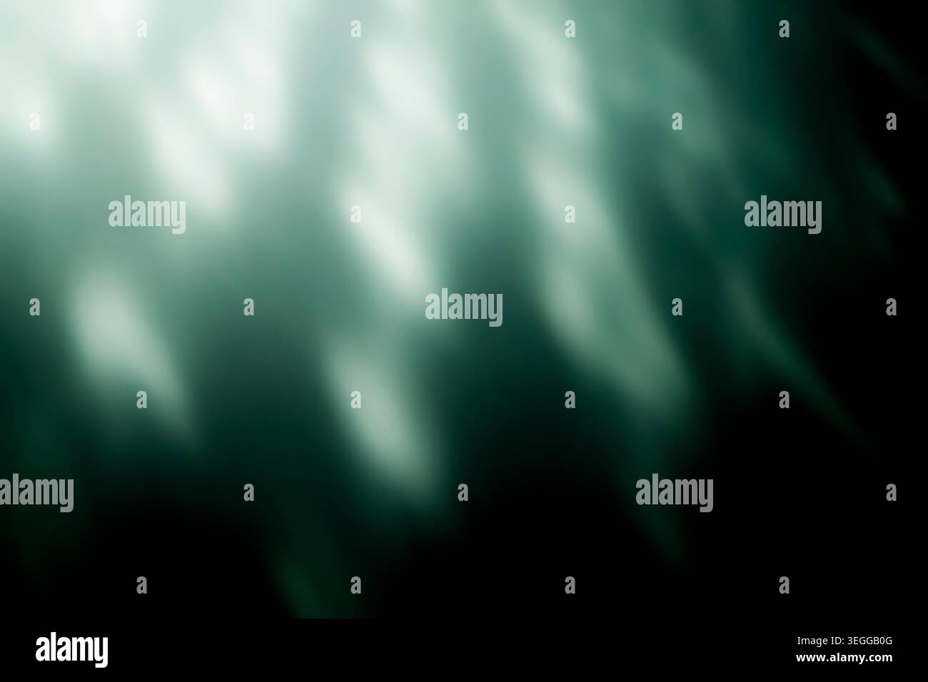 Abstract green light caustics and blurred glowing rays on black Stock Photo