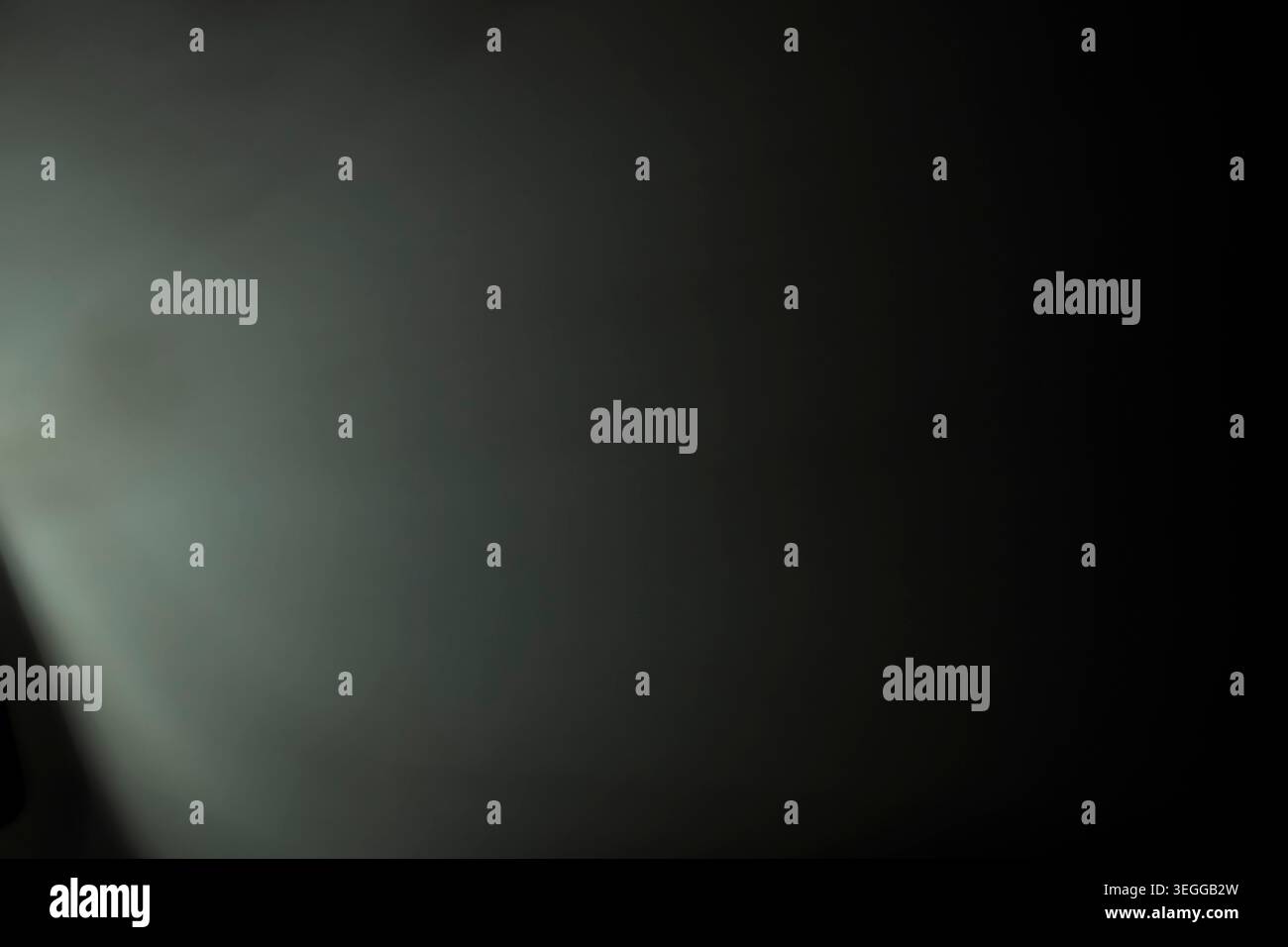 Minimalist smooth dark background with subtle green gradient light and heavy vignette Stock Photo