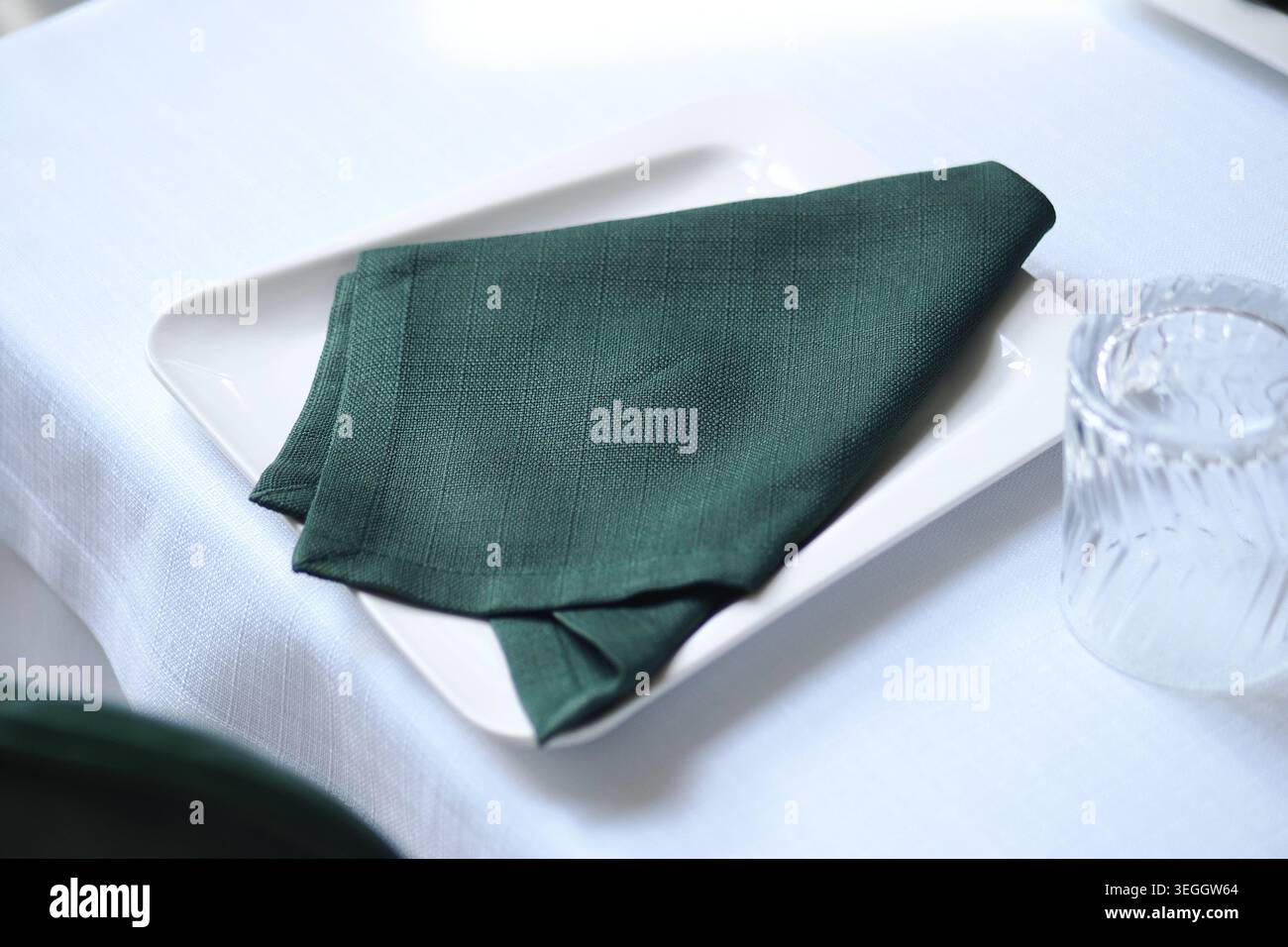 Table setting with a folded napkin on a plate Stock Photo