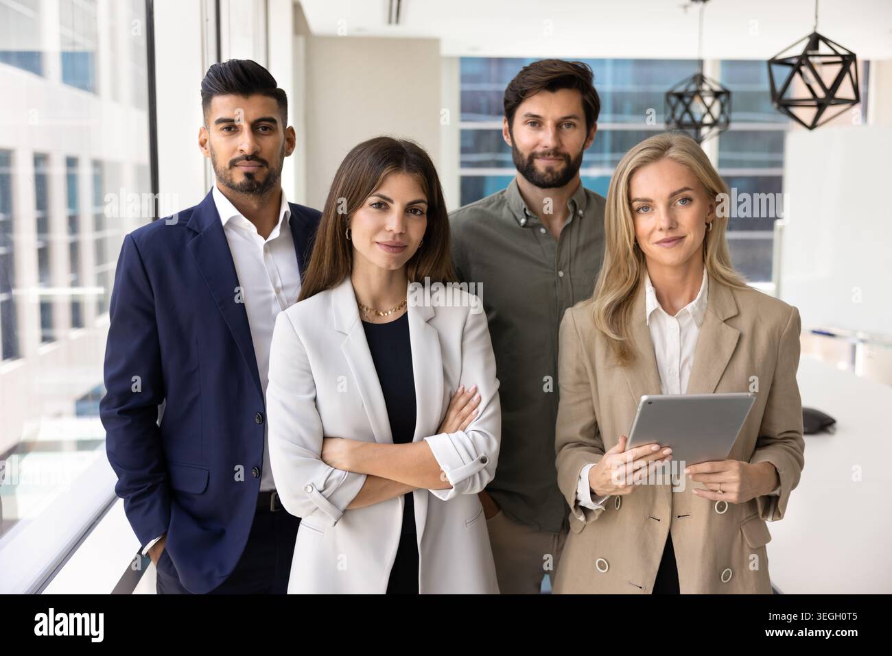Confident business team standing in modern office Stock Photo