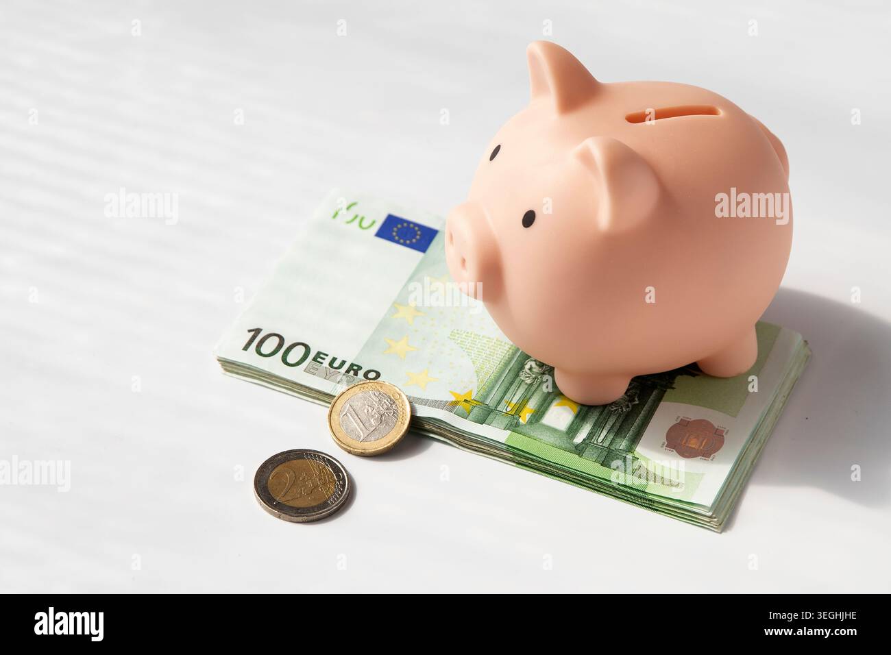 Pink piggy bank with euro coins on stack of euro banknotes Stock Photo ...