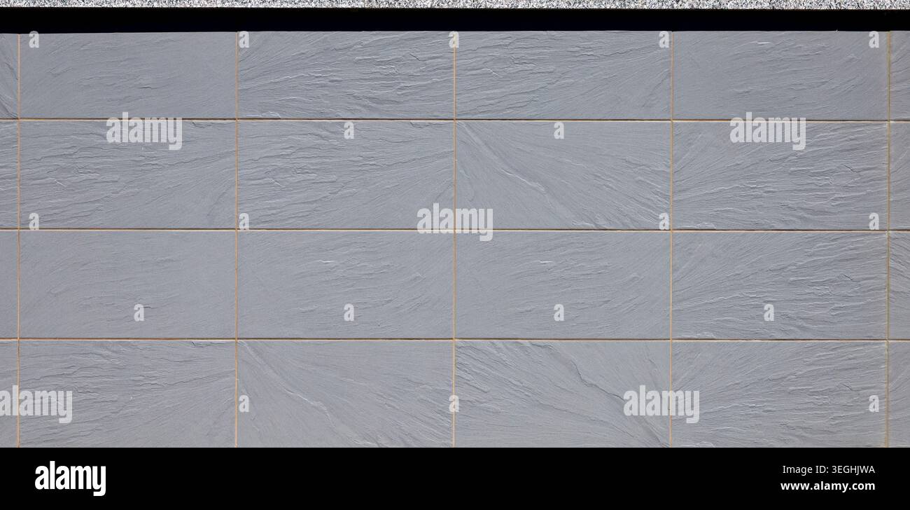 Elegant large gray rectangle stoneware tiles with slate effect. Background and texture. Stock Photo