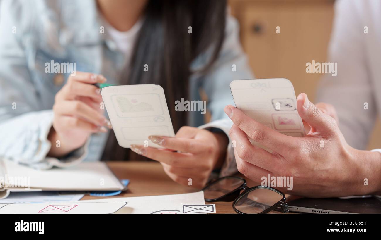 Designers collaborating on mobile application prototyping and user experience Stock Photo