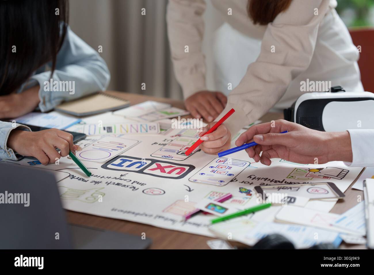Three people collaborating on UX UI design for mobile app development Stock Photo