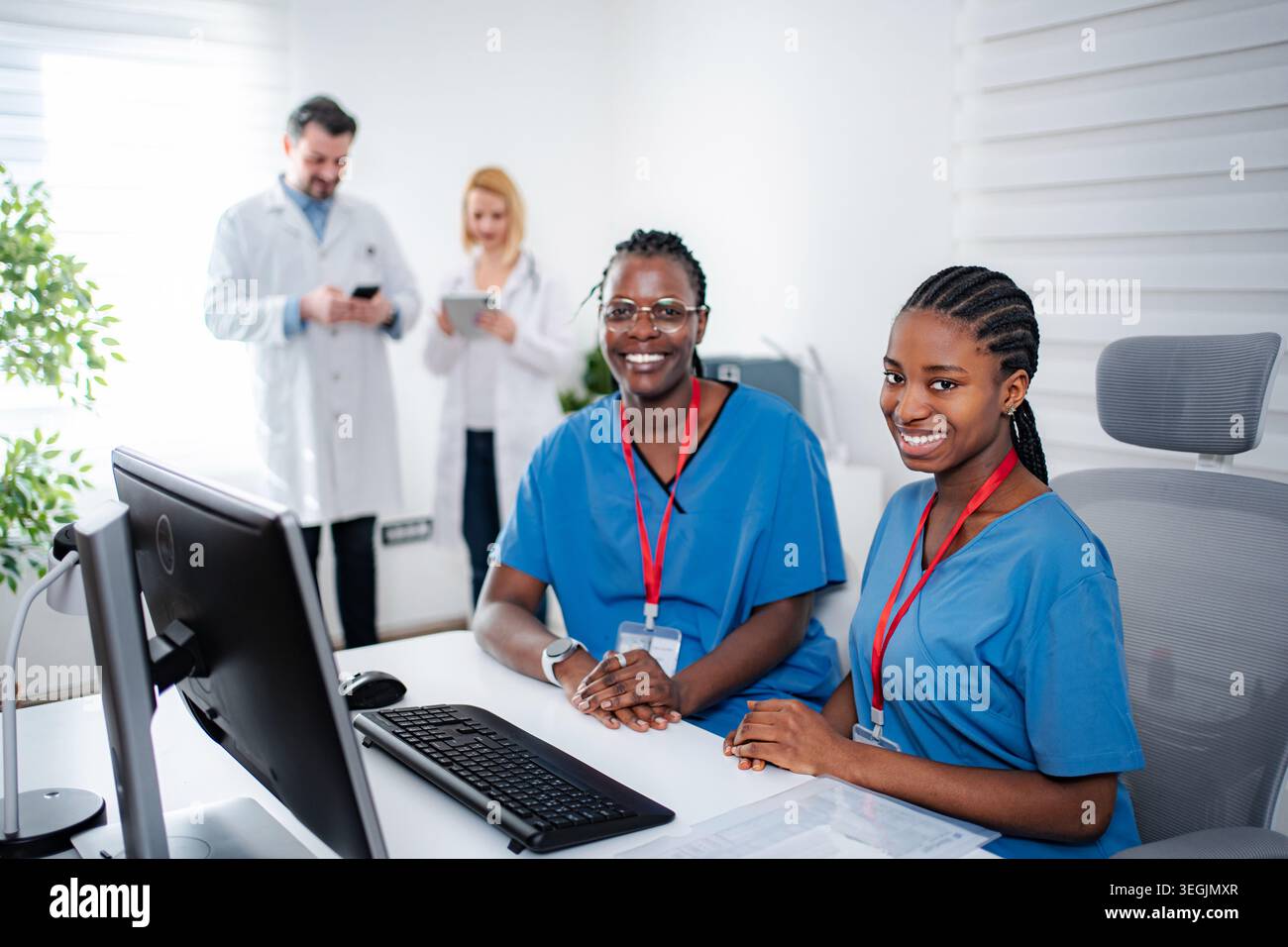 Two smiling female nurses working in hospital office Stock Photo