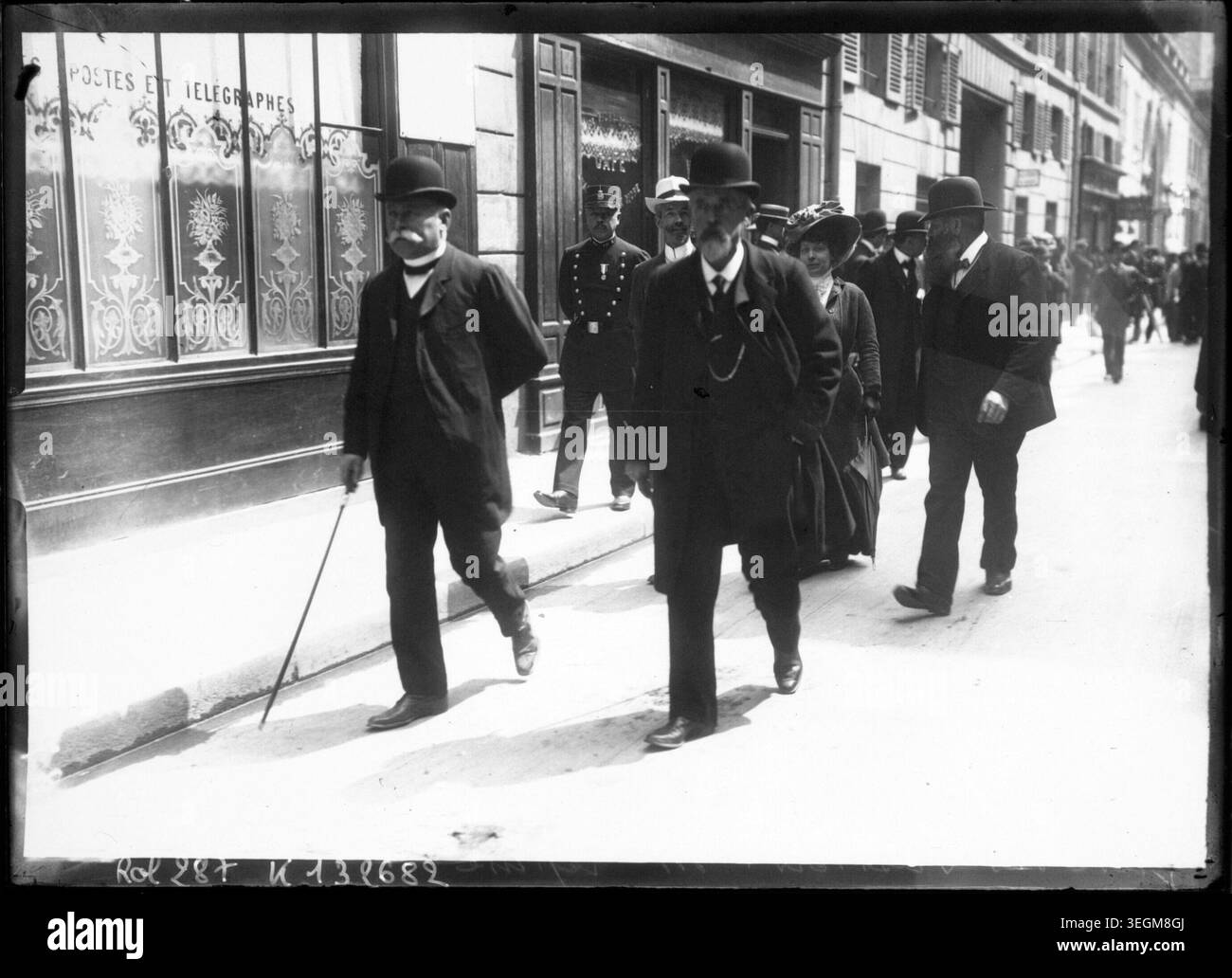 Louis Lépine supervises postal workers during a strike in May 1909. The press photograph records the labor unrest affecting French postal personnel and documents civic tension in early 20th-century France. Stock Photo