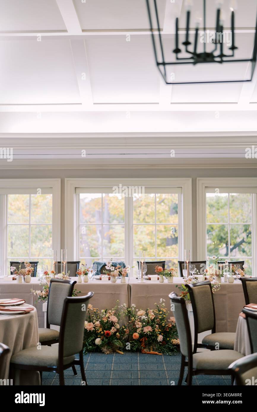 Sunlit space for celebration. Luminous dining area with elegant table settings Stock Photo