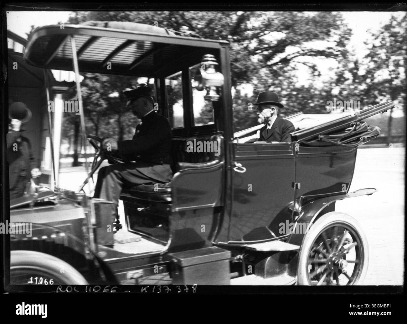 Louis Lépine, prefect of police, rides in an open automobile in Paris, France, in 1910. The press photograph records the official appearance of the police chief during early 20th-century Parisian public events. Stock Photo