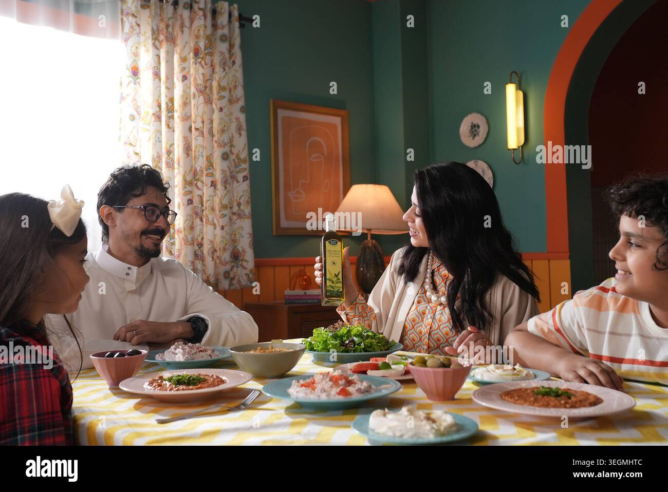 amily gathered around dining table at home Stock Photo