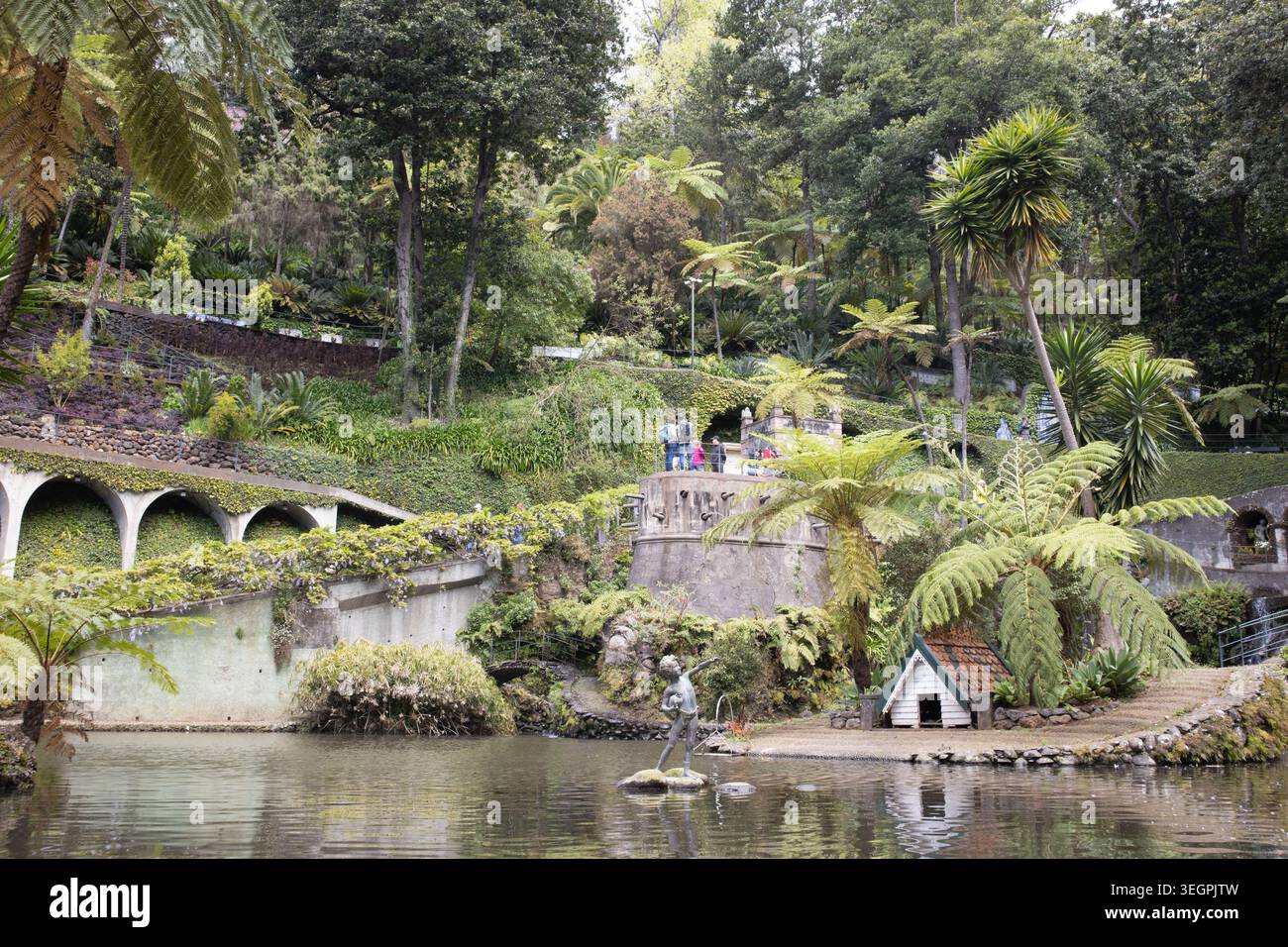 Tourists watching the lake and waterfall at Monte Palace Tropical Garden in Funchal, Madeira. Stock Photo