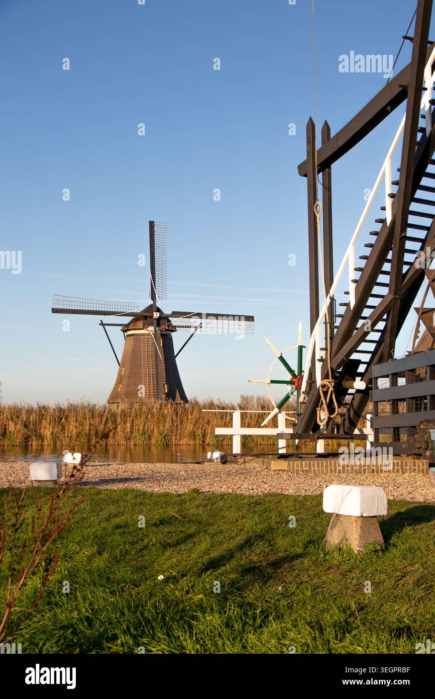 Historic windmill beside a calm canal in Kinderdijk, Netherlands ...