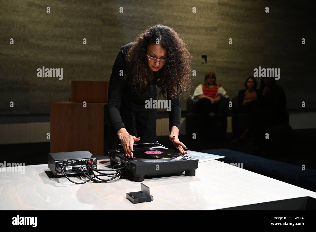 Acmi Reverb Yasmine Sharaf, Music Curator, selecting a record in the listening room ...