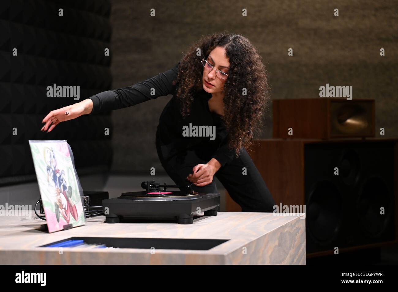 Acmi Reverb Yasmine Sharaf, Music Curator, selecting a record in the listening room ...