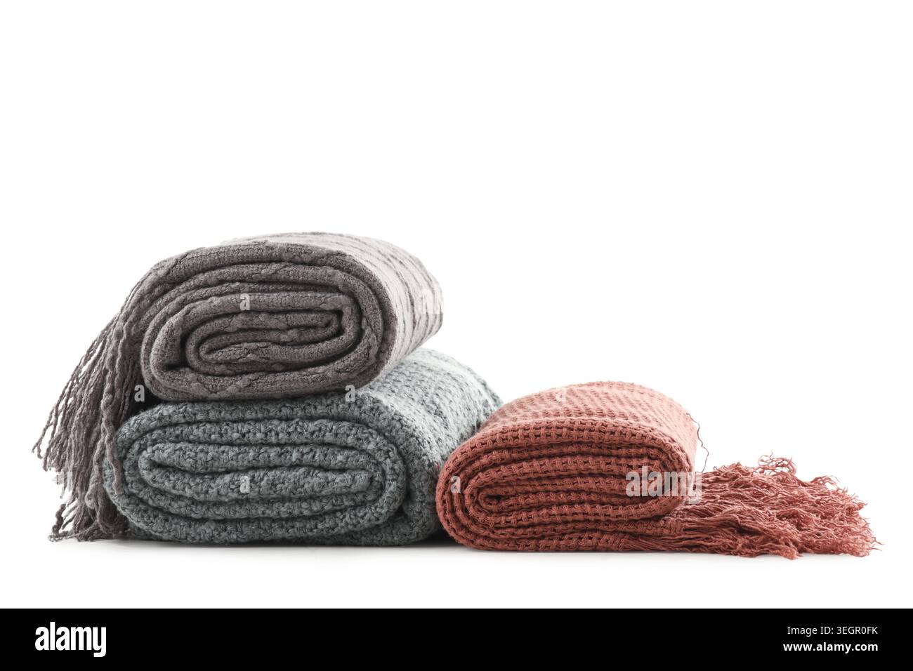 Stack of different knitted blankets isolated on white background Stock Photo