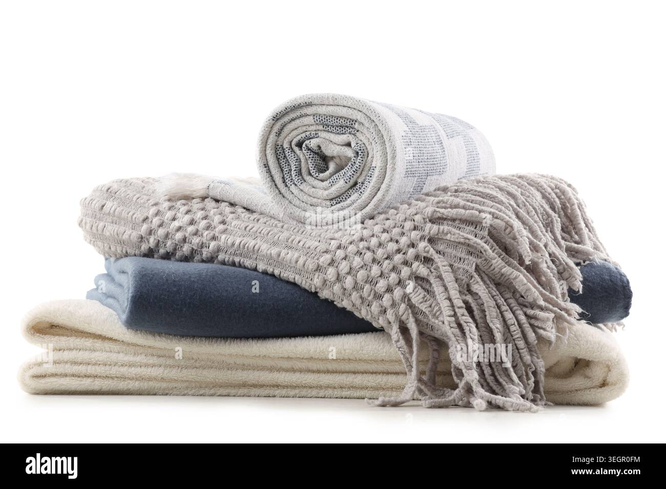 Stack of different soft blankets isolated on white background Stock Photo