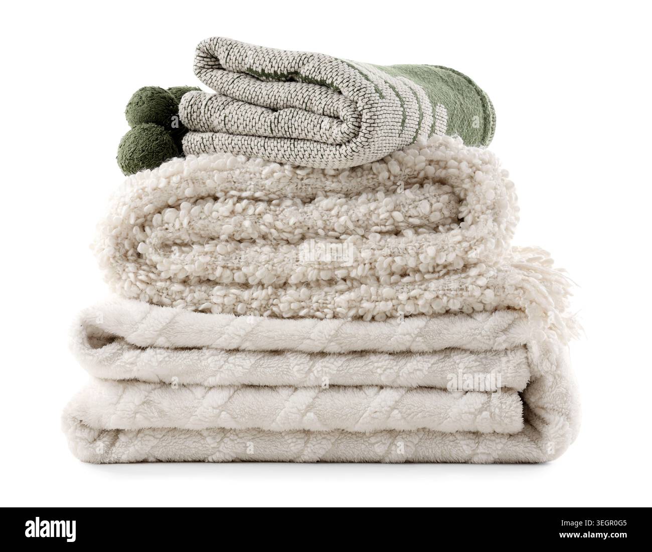 Stack of different cozy blankets isolated on white background Stock Photo