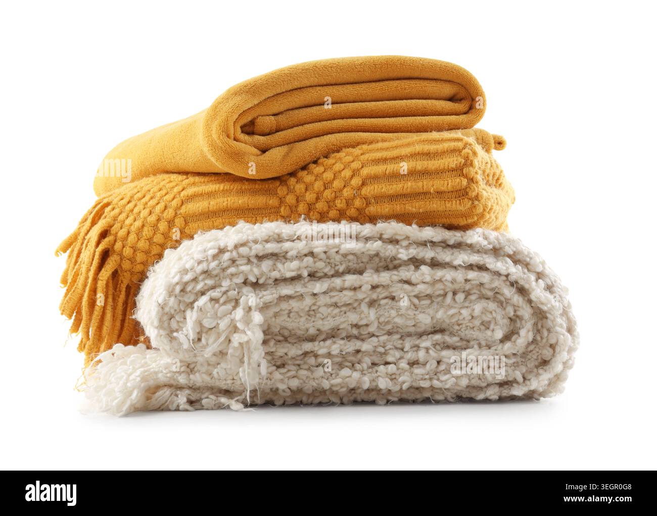 Stack of cozy knitted blankets isolated on white background Stock Photo